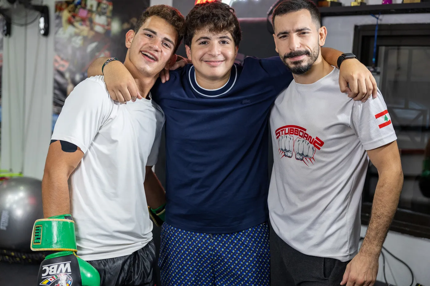 Three smiling members arm in arm after a session at The Stubborns